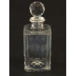 A cut glass decanter with silver collar, hallmarked London 1963, maker Asprey & Co. Ltd. Approx. 9