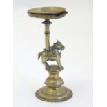 An Indian cast brass candle stand with horse detail. Approx. 7 1/4" high Please Note - we do not