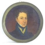 A 19thC tondo oil on board depicting a portrait of a Georgian gentleman. Approx. 7 1/4" diameter
