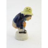 An early 19thC Staffordshire comical / novelty pepper pot modelled as Roger Giles squatting. Approx.
