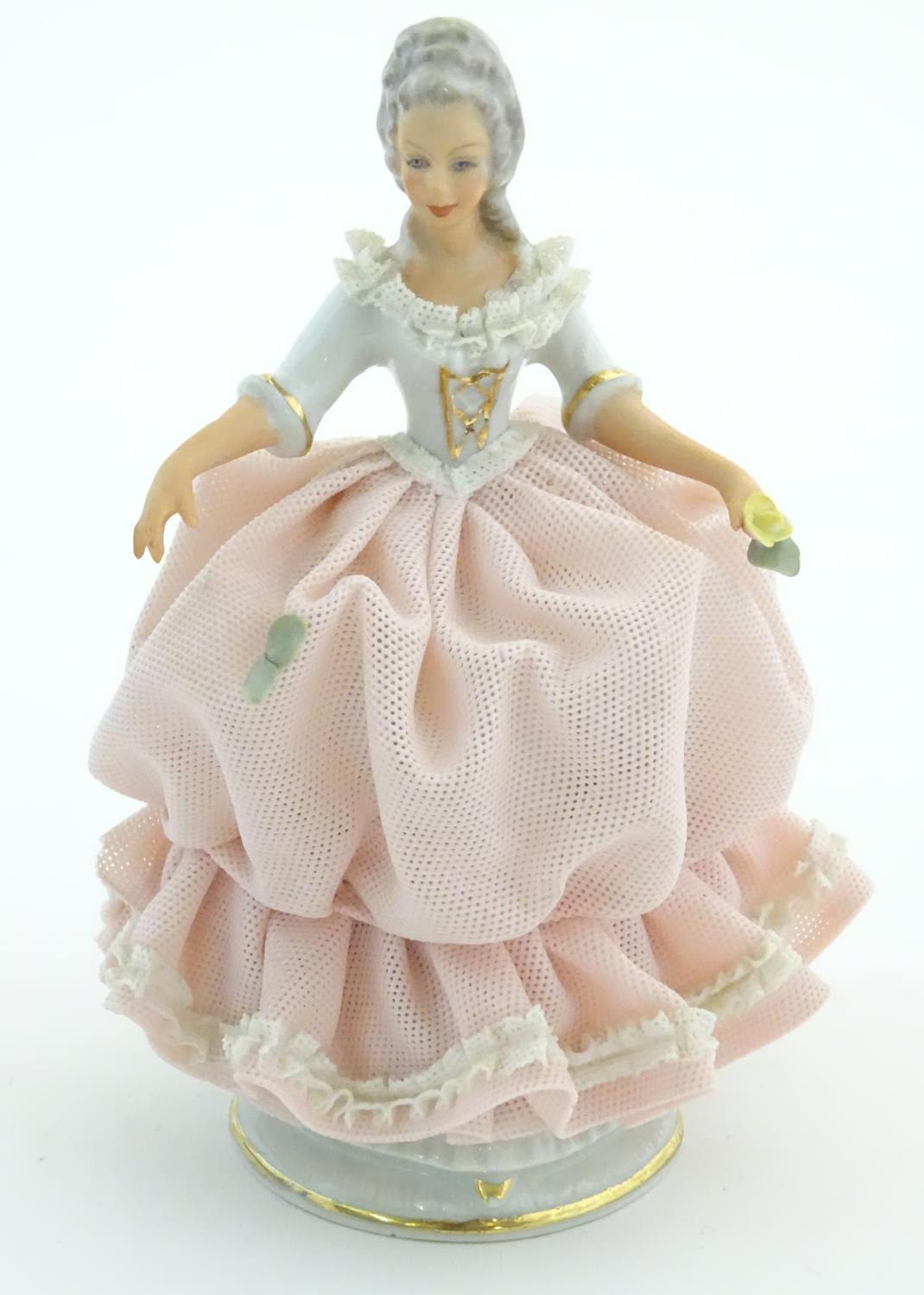 A Dresden model of a lady with a porcelain lace dress. Marked under. Approx. 5 3/4" high Please Note