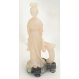 A Chinese soapstone carving depicting a young woman with a quqin / zither musical instrument.