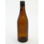 A 20thC brown glass beer bottle, with six point star and NBC monogram (Northampton Brewery