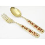 Scandinavian silver: A silver gilt spoon and fork with red enamel decoration, engraved July 1957,