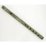 An Oriental jade coloured hardstone flute. Approx. 15 1/4" Please Note - we do not make reference to