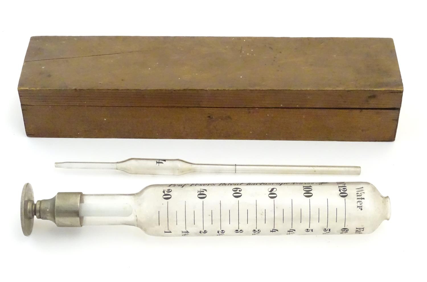 A 20thC cased glass Lactoscope with metal base, the interior with label: 'Professor Feser's Patent - Image 5 of 7