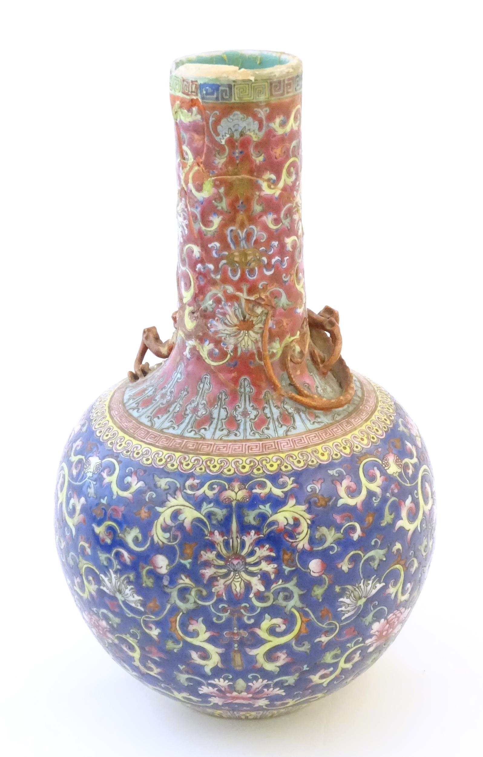 A Chinese bottle vase with scrolling floral and foliate detail, and applied dragon decoration to - Image 4 of 6