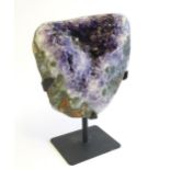 An amethyst crystal geode with polished edge. Mounted on a stand. Amethyst approx. 7 3/4" high