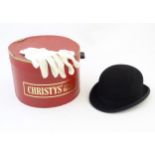 Hunting: a Harrods reinforced bowler hat, size 7 1/8 (58) with a Christys' hat box and a pair of