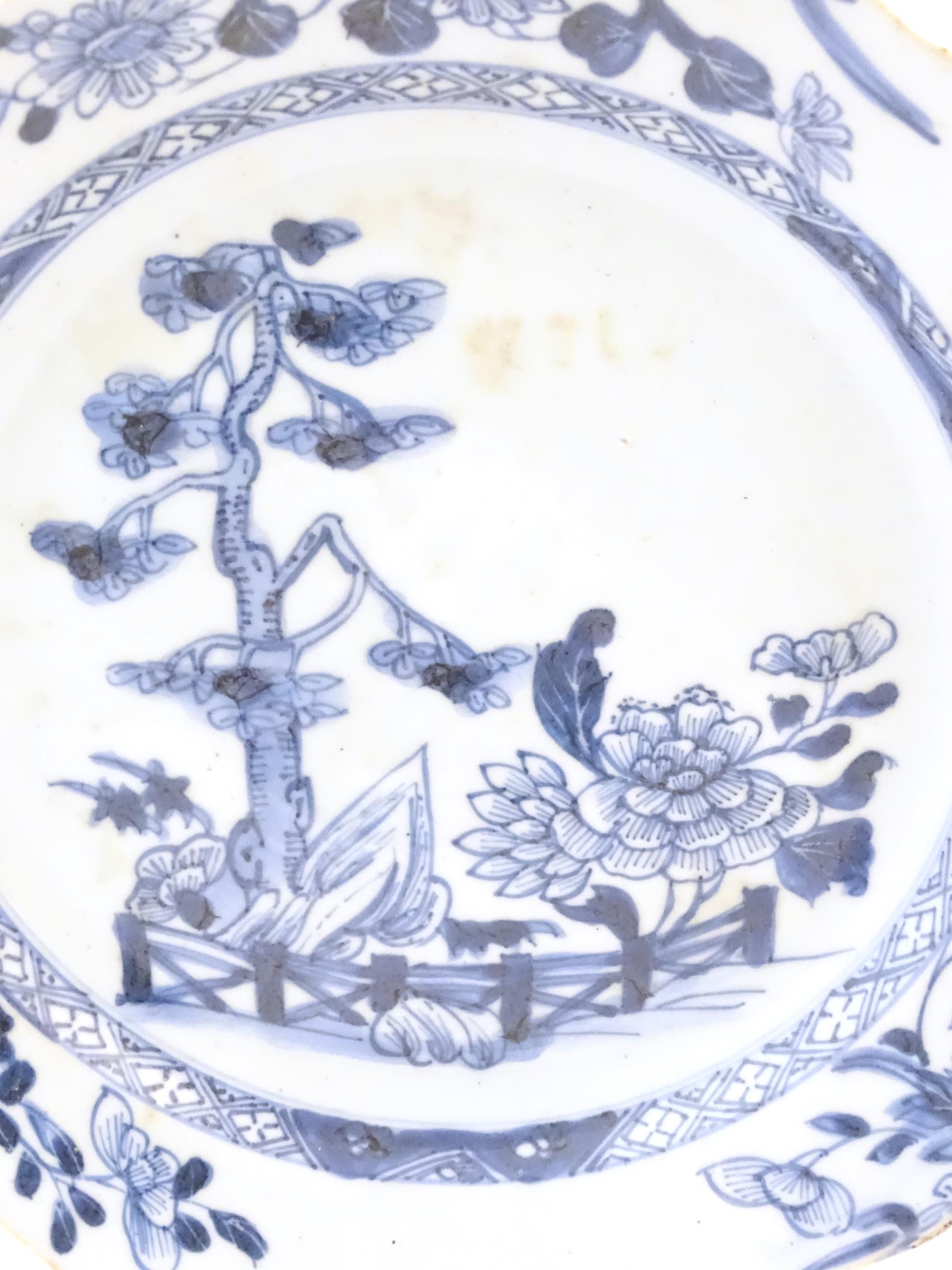 A Chinese blue and white plate with a lobed rim decorated with a landscape scene with trees and - Image 4 of 4