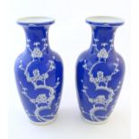 A pair of Oriental vases with a blue glaze decorated with prunus flowers in blossom. Character