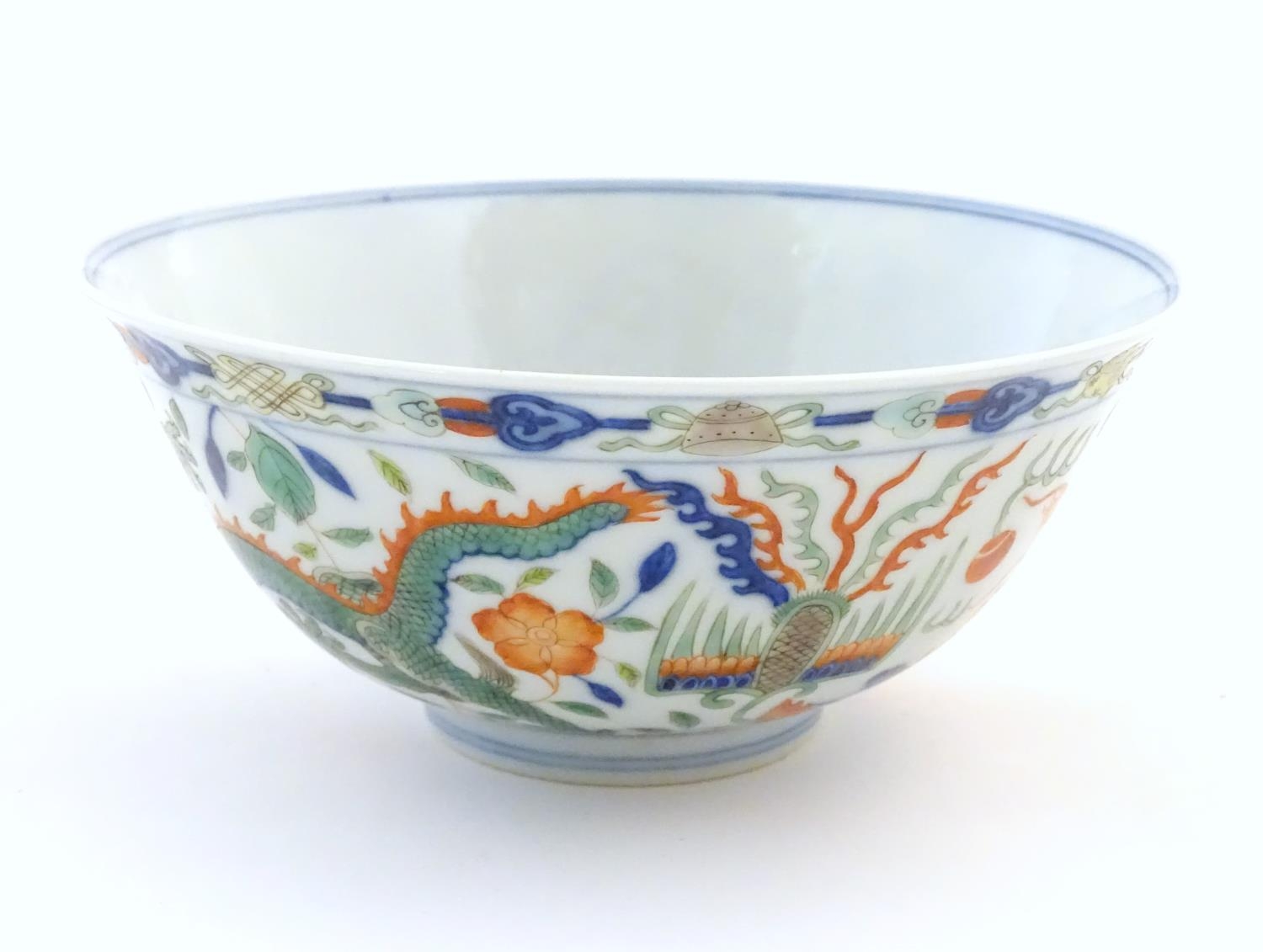 A Chinese bowl with dragon and flaming pearl detail, with flowers, foliate and stylised clouds. - Image 5 of 6