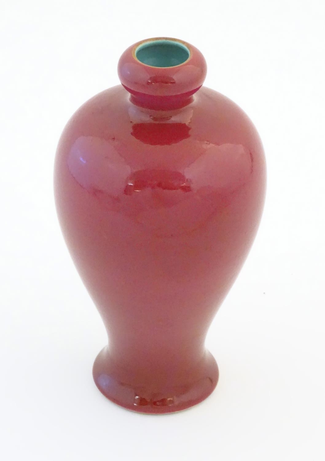 A Chinese baluster vase with a bulbous rim, with a ruby pink glaze and a turquoise interior. - Image 6 of 9
