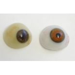 Two 19thC prosthetic glass human eyes with brown irises. Largest approx. 1" wide (2) Please Note -