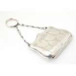 A silver purse with engraved decoration and leather lined interior, hallmarked Birmingham 1914,