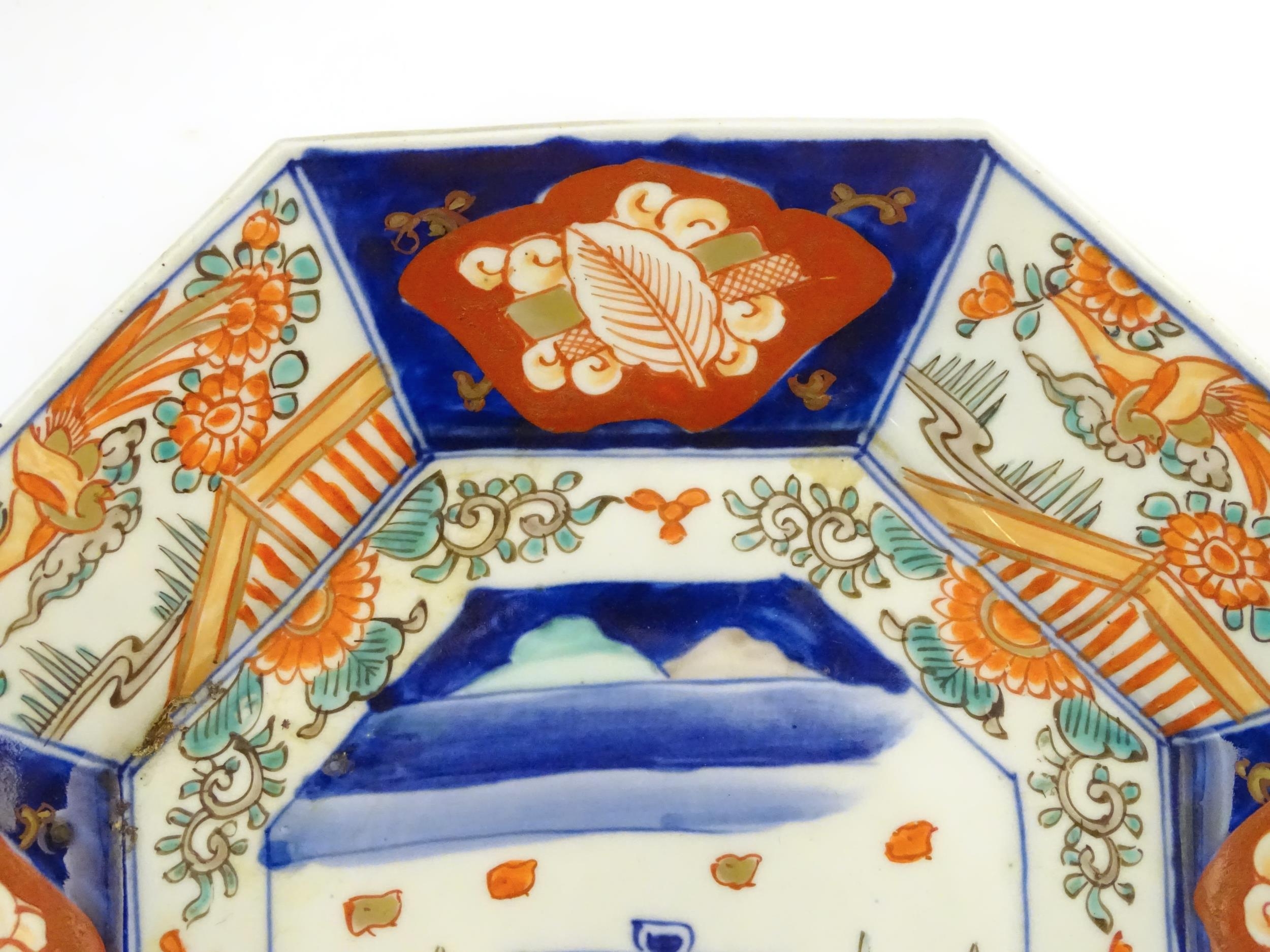 A Japanese octagonal plate in the Imari palette decorated with birds, flowers and foliage, with - Image 6 of 6