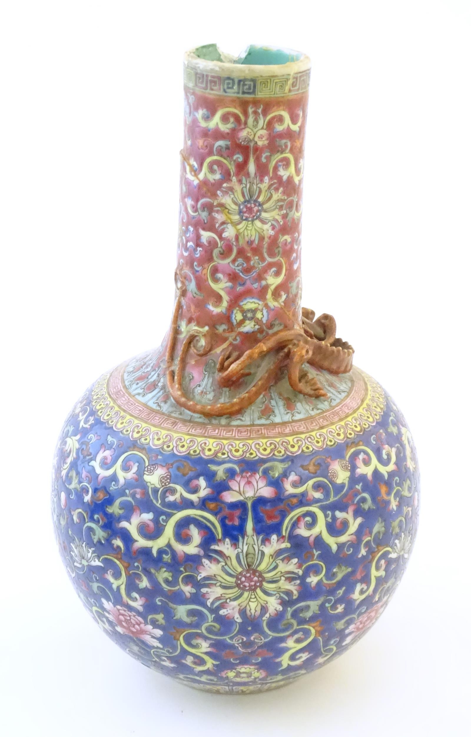 A Chinese bottle vase with scrolling floral and foliate detail, and applied dragon decoration to - Image 3 of 6