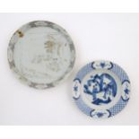 A Chinese blue and white plate decorated with two figures in a landscape scene, the border with