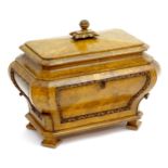 A Regency burr elm sarcophagus wine cooler, having a carved handle above a moulded lid and carved