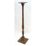 A late 19thC torchiere with a squared top above a reeded tapering stem and shaped base. 60" high.