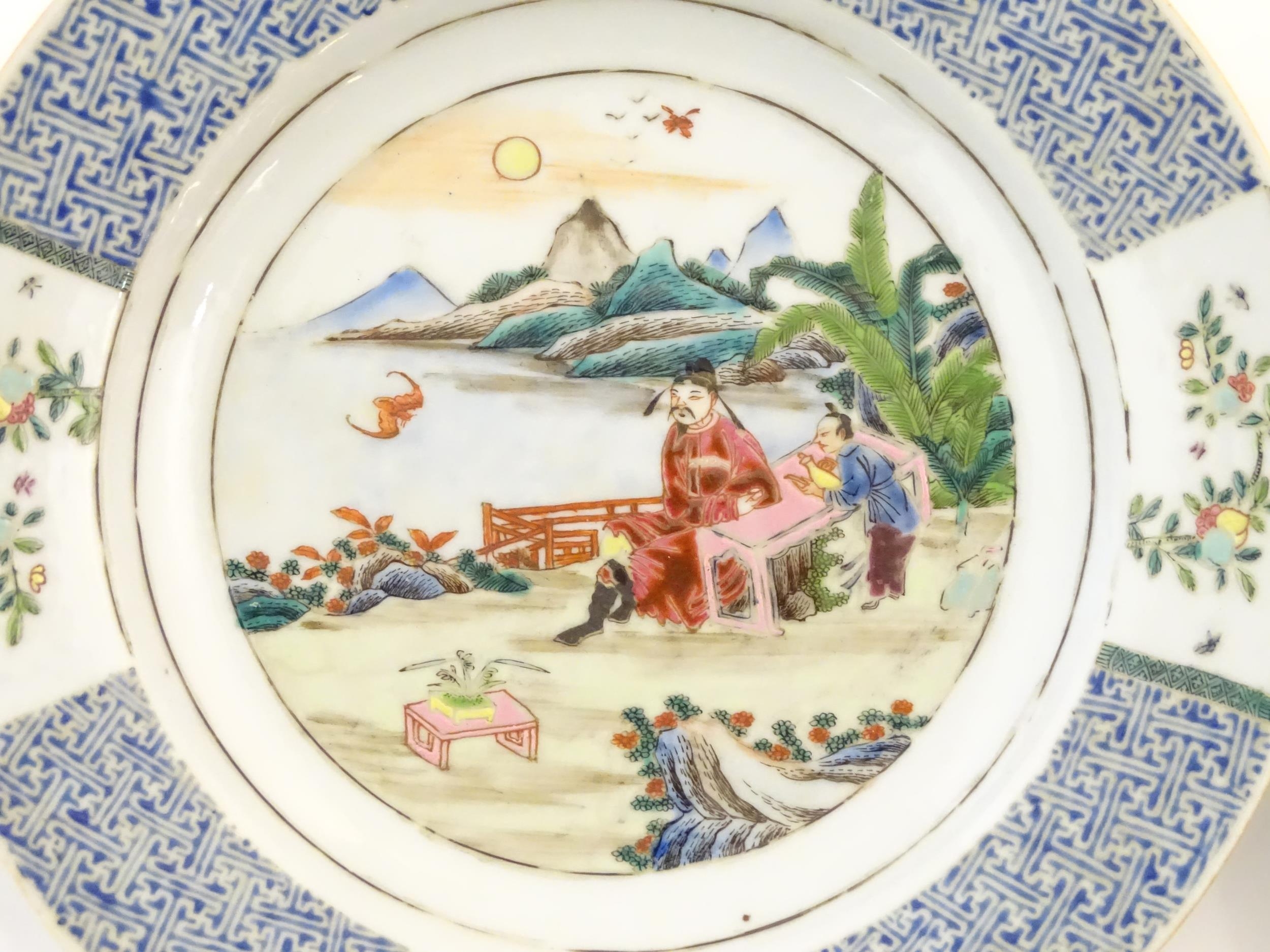 A pair of Chinese plates depicting a two figures in a garden watching a bat, with sea and - Image 5 of 5