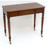 A 19thC mahogany chamber table in the manner of Gillows with a rectangular top above a long drawer