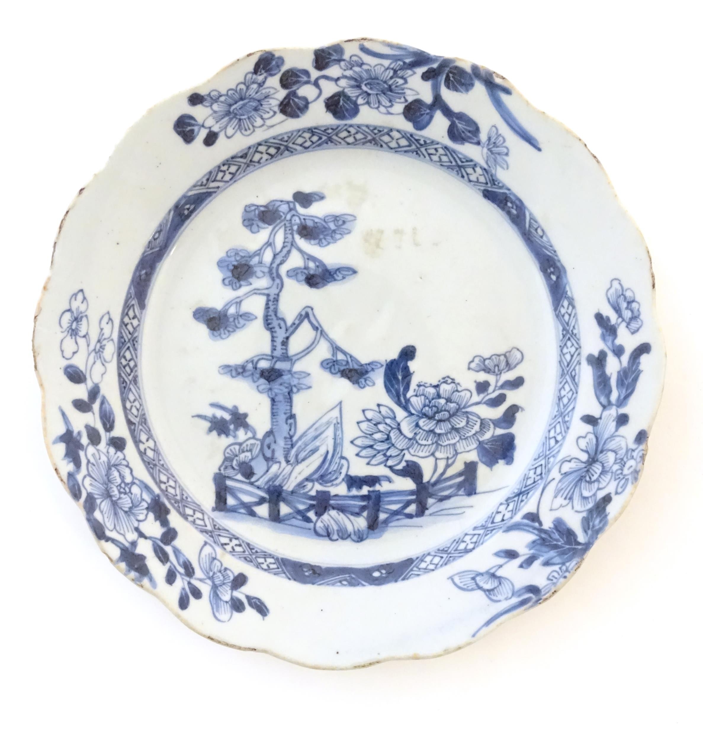 A Chinese blue and white plate with a lobed rim decorated with a landscape scene with trees and - Image 3 of 4