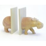 Carved novelty bookends modelled as the front and back of a hippopotamus. Approx. 6" high Please