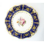 A Bloor Derby plate with floral motif to centre and floral and foliate gilt border. Marked under.