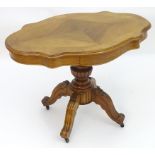 A late 19thC / early 20thC French walnut centre table with a shaped top and two opposing drawers