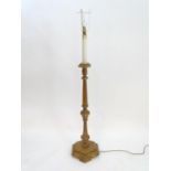 A 20thC pine standard lamp, of hexagonal stepped sectional form, with gilt edging and faux candle