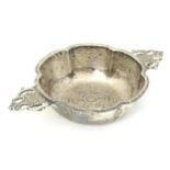 A silver quaich with twin handles and embossed rose decoration to base, hallmarked London 1905,