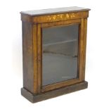 A Victorian walnut pier cabinet with a rectangular top and moulded edges above satinwood marquetry