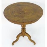 A 19thC Sorrento table with a profusely inlaid marquetry top and having a turned pedestal base