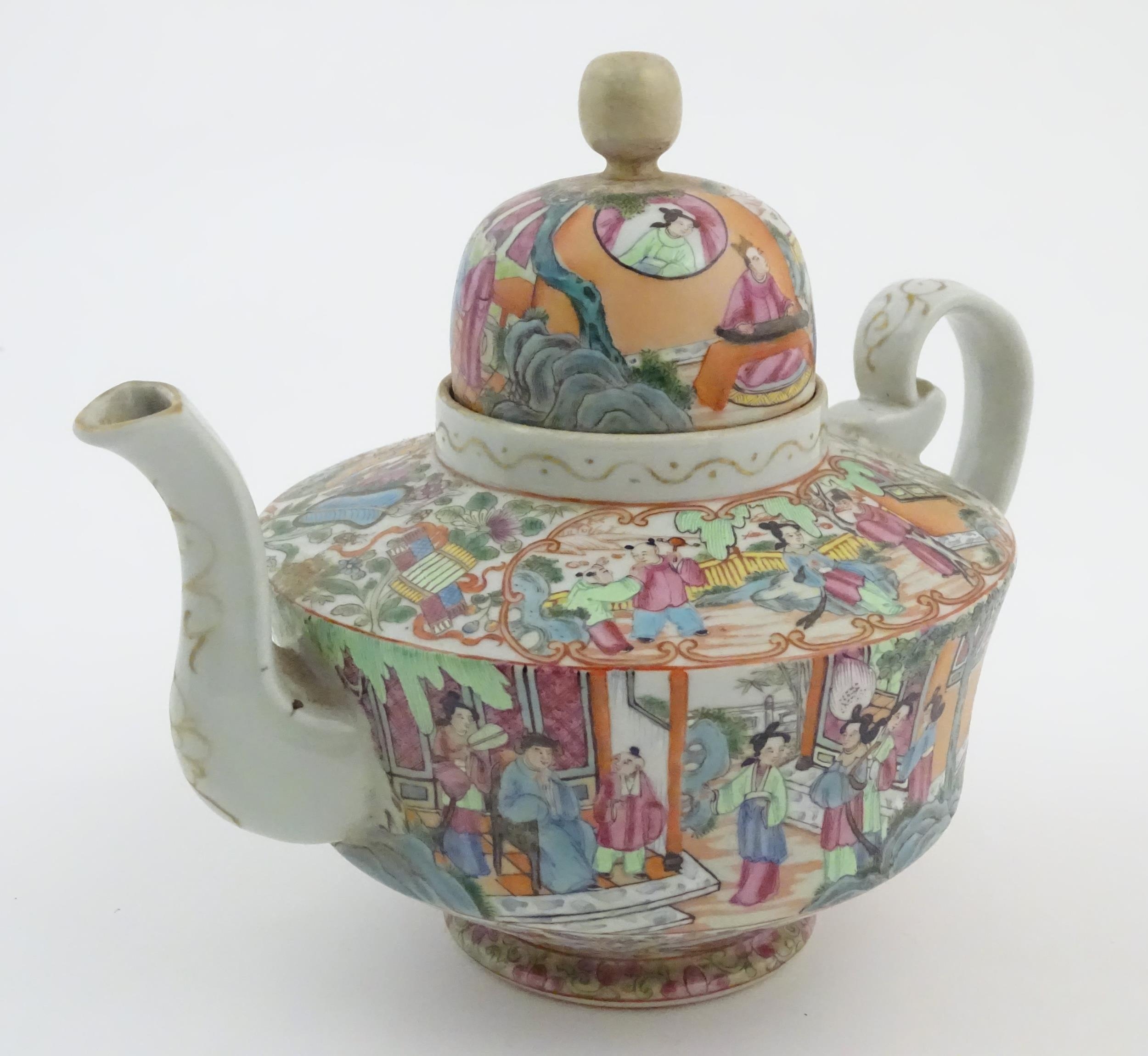 A Chinese famille rose teapot decorated with figures drinking tea, figures on a terrace with fans,