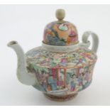 A Chinese famille rose teapot decorated with figures drinking tea, figures on a terrace with fans,