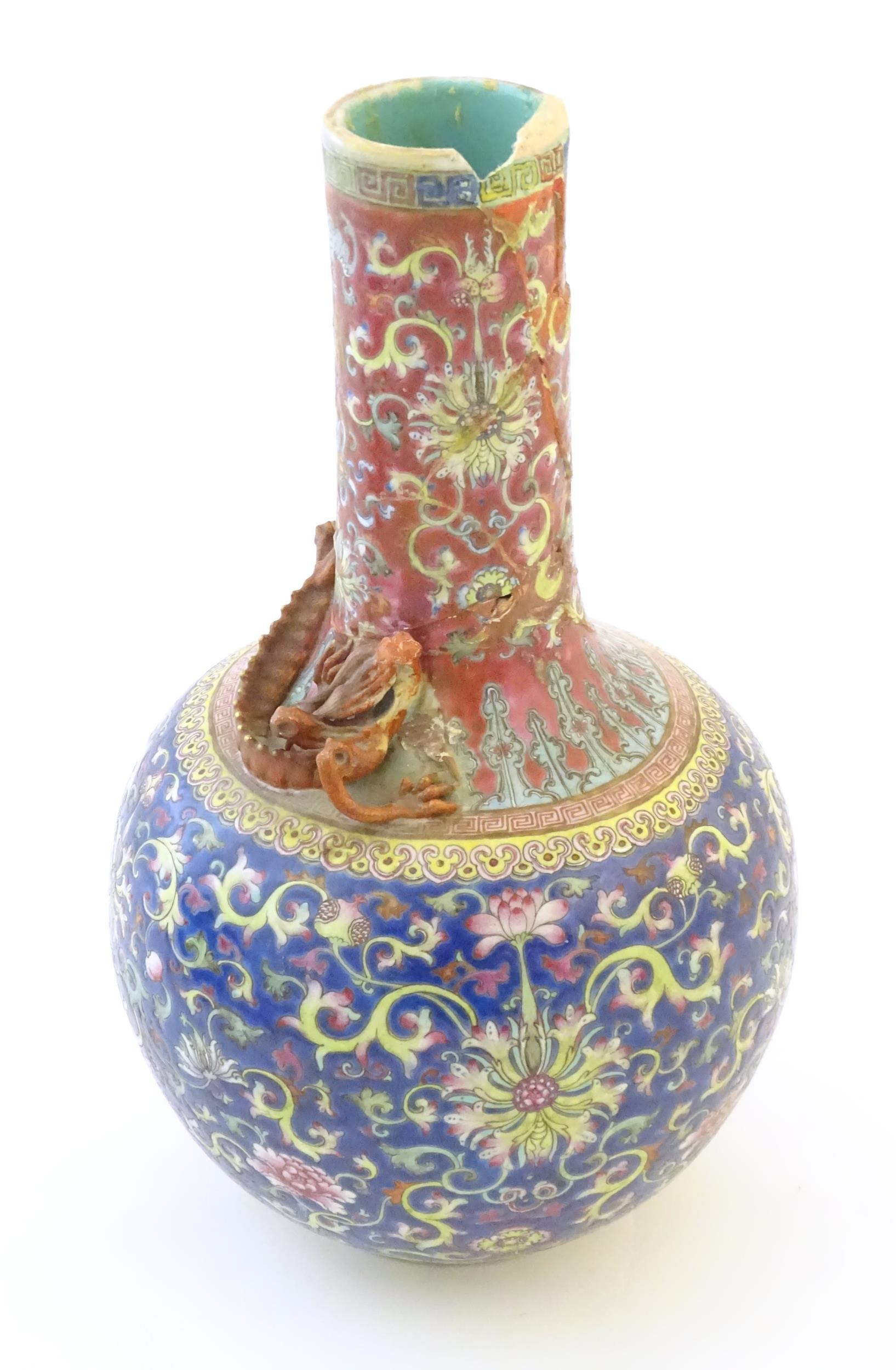 A Chinese bottle vase with scrolling floral and foliate detail, and applied dragon decoration to - Image 5 of 6