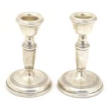 A pair of silver candlesticks hallmarked 1971, maker B & Co. Approx. 4 1/4" high (2) Please Note -