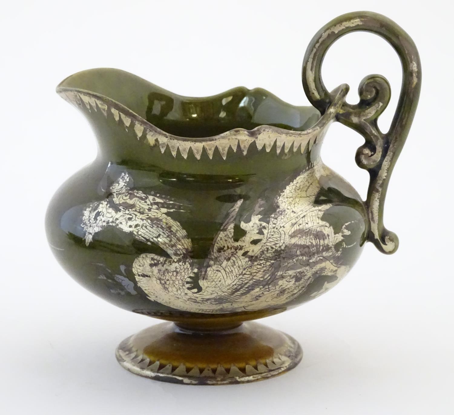 An Oriental pedestal cream jug with gilt dragon detail. Impressed marks under. Approx. 4" high