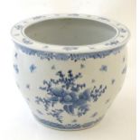 A Chinese blue and white planter / jardiniere decorated with flowers, foliage, insects, fruit and