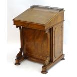 A 19thC burr walnut Davenport, having a metal pierced gallery above a writing slope opening to