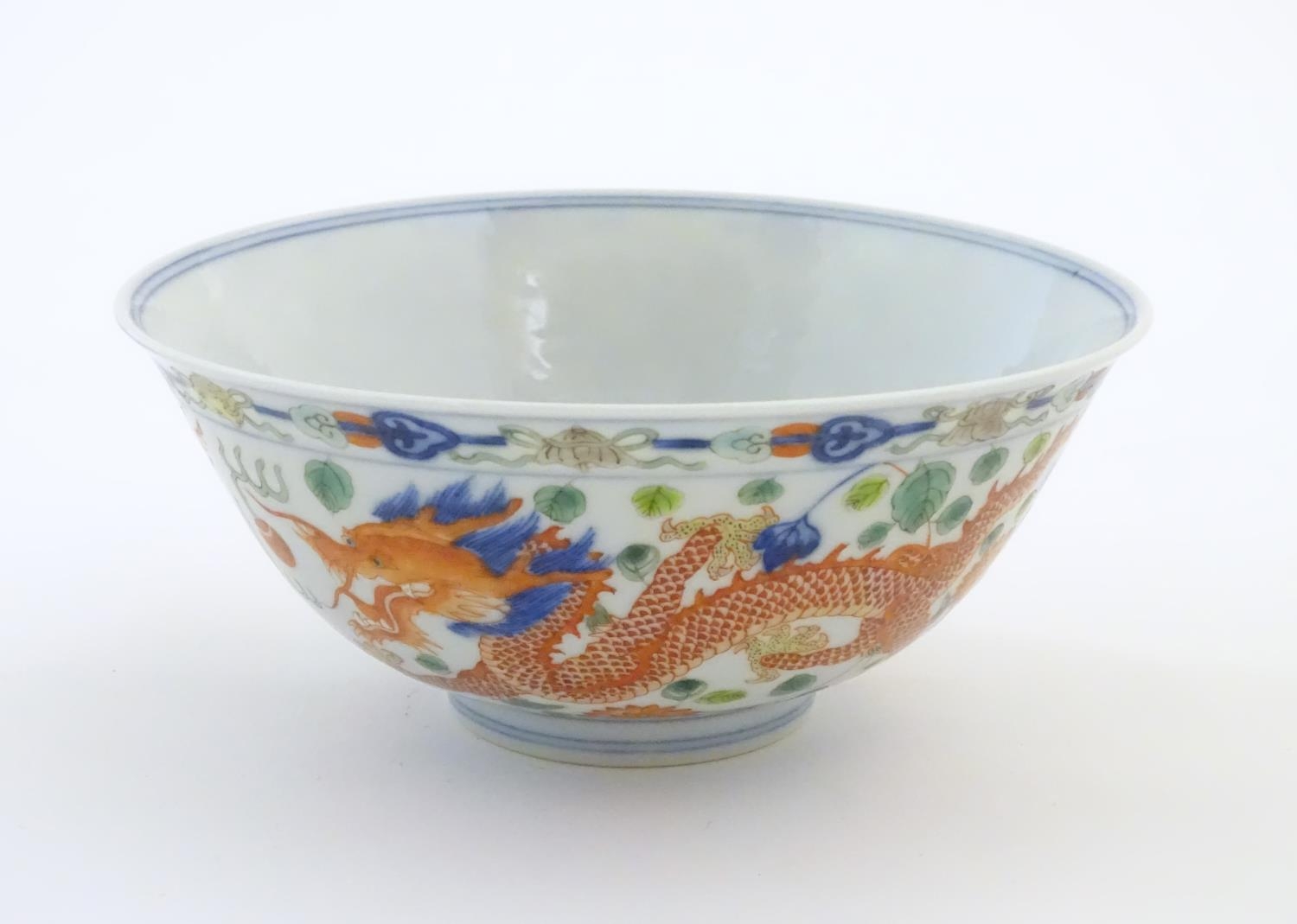 A Chinese bowl with dragon and flaming pearl detail, with flowers, foliate and stylised clouds. - Image 3 of 6