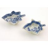 Two blue and white pickle dishes decorated with pagoda buildings, birds, figures and a bridge.