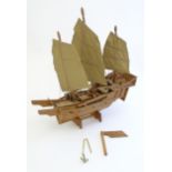 A mid 20thC scratch built wooden model of a boat with canvas sails. Approx. 19" high x 17 1/2"