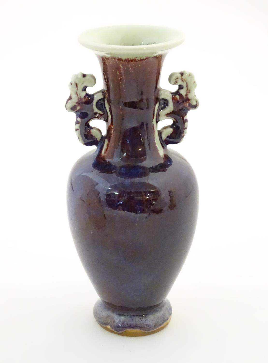 An Oriental twin handled vase, the handles with foliate detail. Approx. 8" high Please Note - we