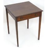 An early 20thC mahogany side table with a single short drawer with ring pull handles and four