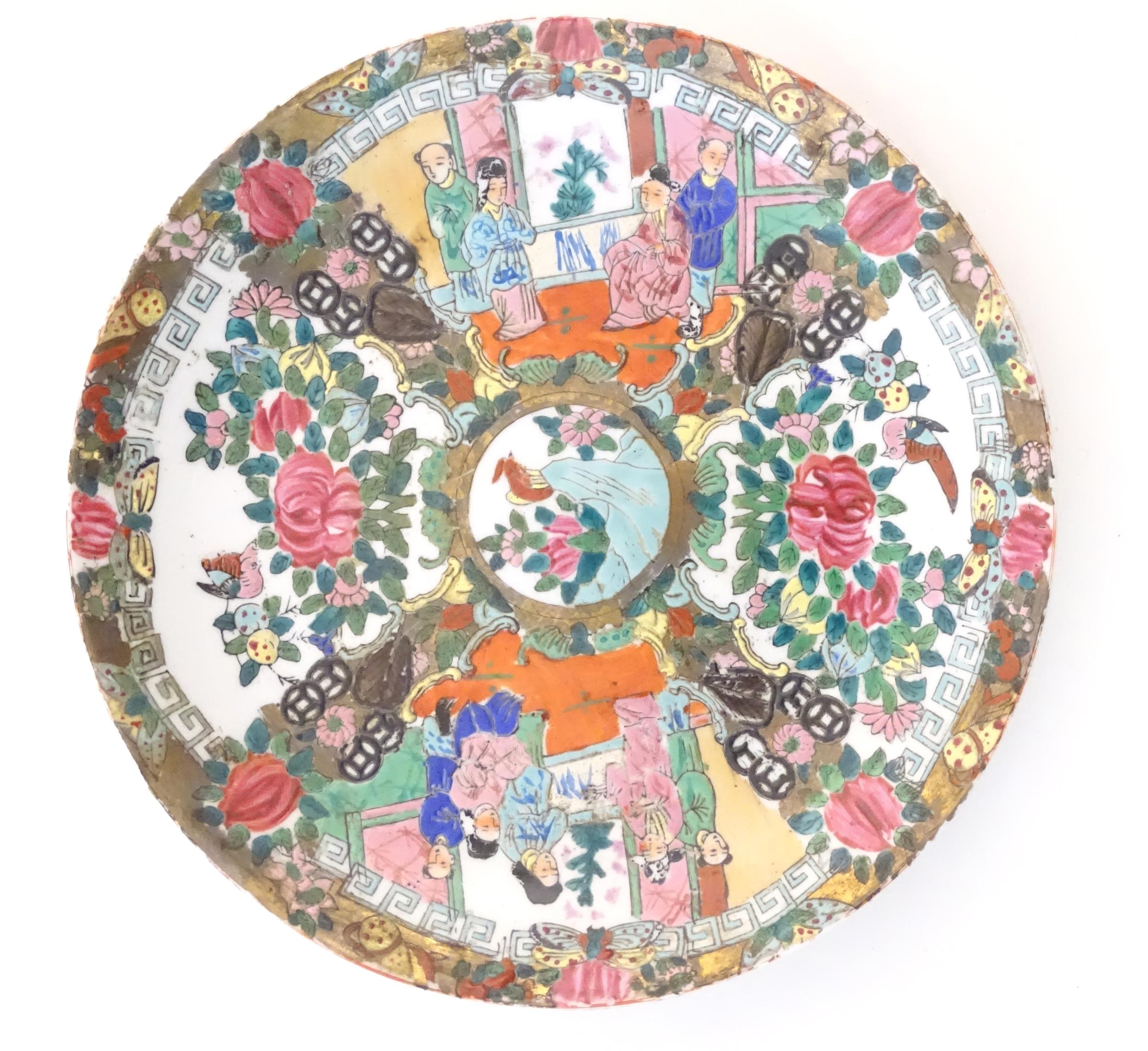 A Chinese / Cantonese plate with panelled decoration depicting flowers, foliage, birds and