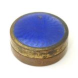 A gilt metal pill box with guilloche enamel decoration to lid and glass liner. Approx. 1 1/4"