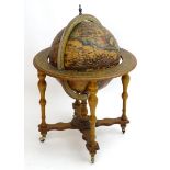 A 20thC novelty drinks cabinet modelled as a globe with applied terrestrial detail, with fitted