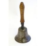 A 20thC hand bell with turned fruitwood handle with banded detail. Approx. 12 1/2" high Please